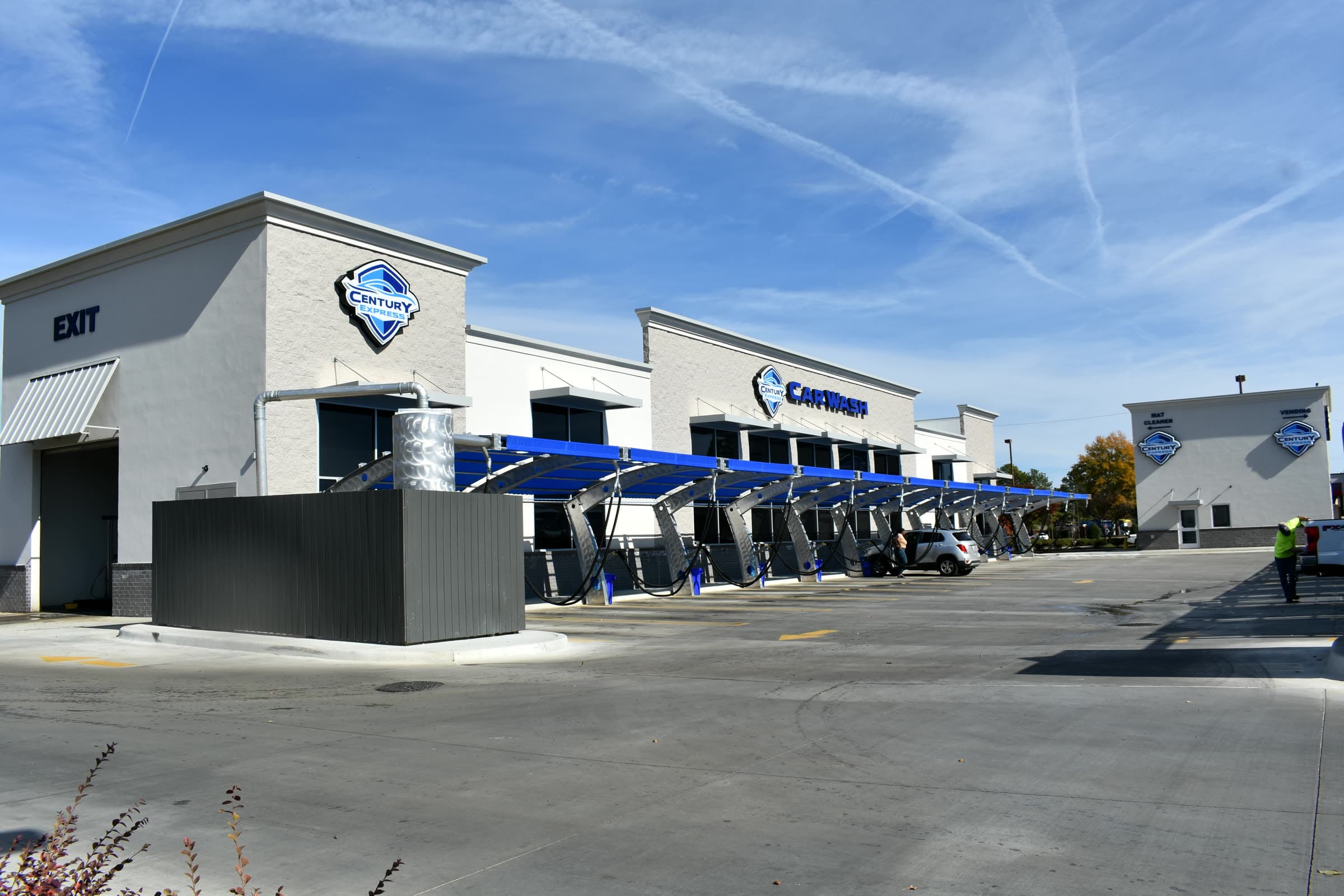 A Century Express Carwash location exterior, with covered wash bays and free vacuum stalls